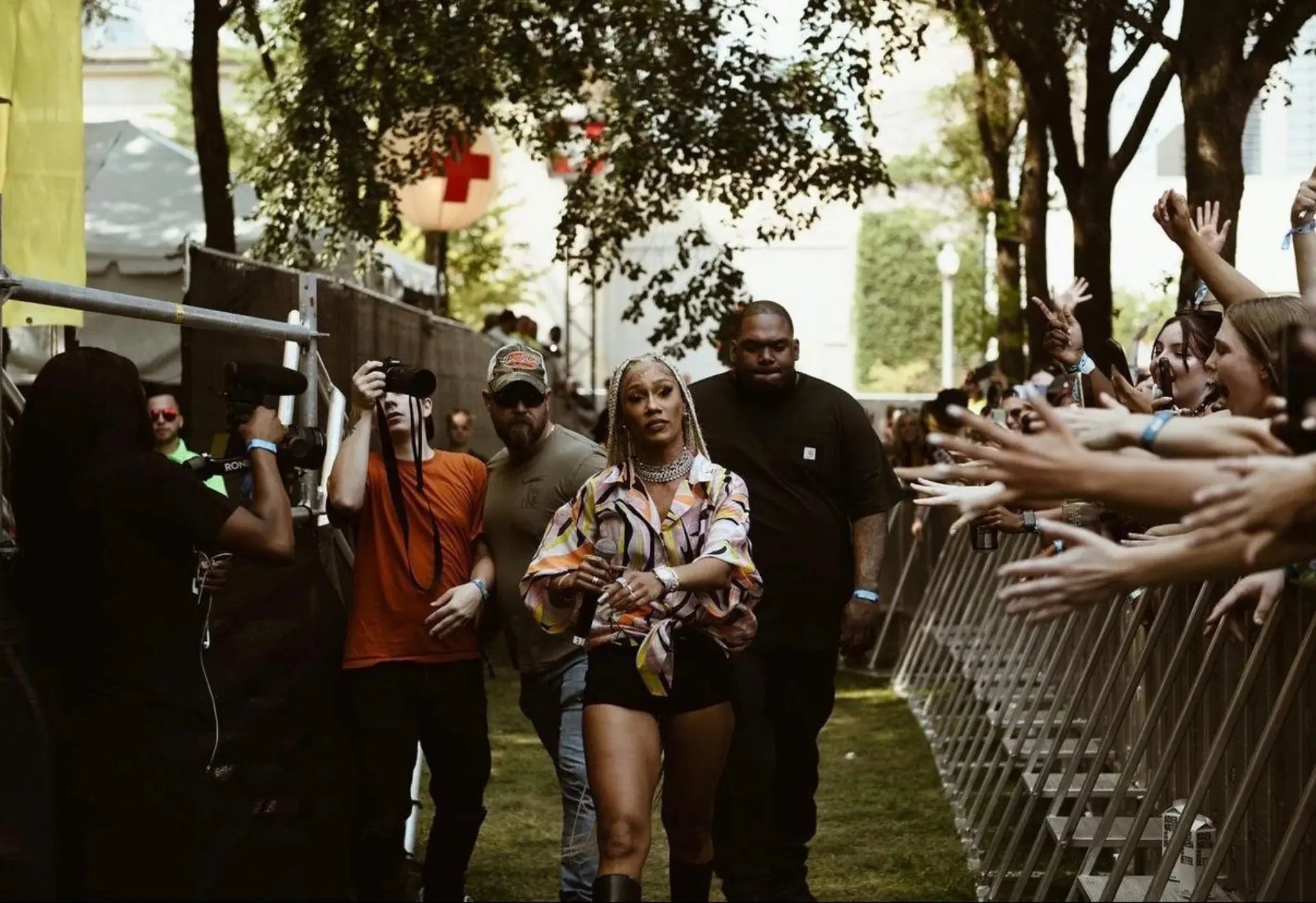 Close-up of a Tactical Elite Protective Services shoulder patch on a uniform during an outdoor security operation.